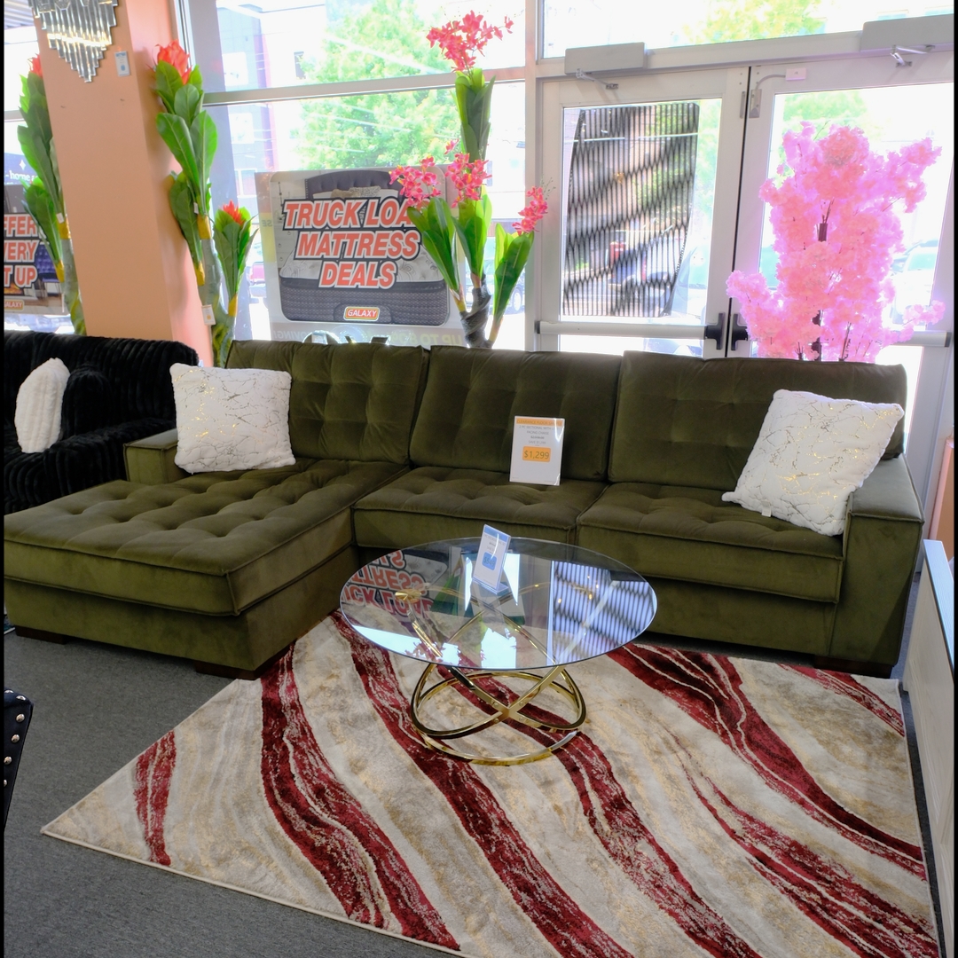 Olive green tufted sectional with chaise in the Galaxy Furniture showroom